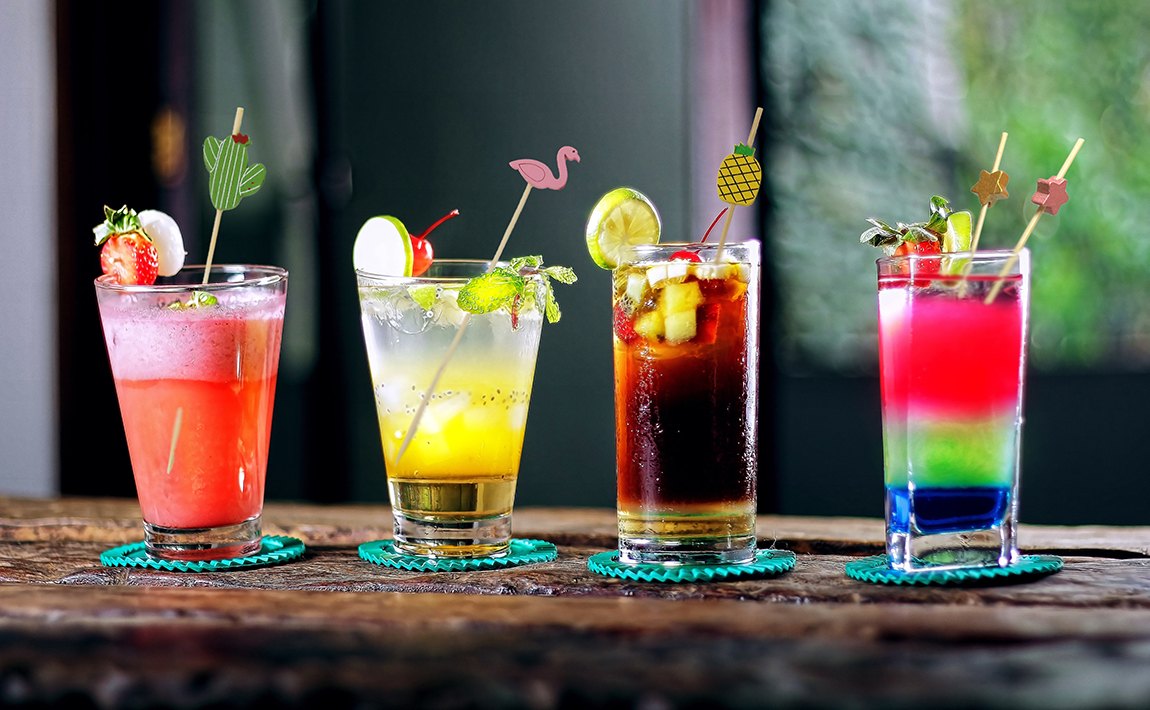 Colorful drinks with bamboo cocktail picks